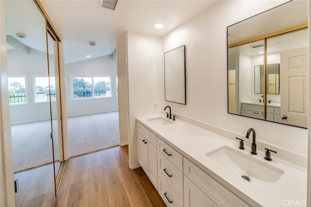 2648 Condor Cir, Corona, CA 92882 - bathroom with wood finished floors, double vanity, lofted ceiling, and recessed lighting