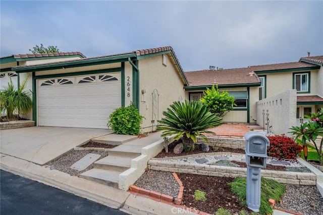 2648 Condor Cir, Corona, CA 92882 - view of front of home with concrete driveway, an attached garage, and stucco siding