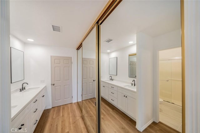 2648 Condor Cir, Corona, CA 92882 - bathroom with wood finished floors, double vanity, and recessed lighting
