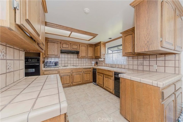 2837 E Mesa Dr, West Covina, CA 91791 - kitchen featuring black appliances, tile countertops, backsplash, light tile patterned flooring, and under cabinet range hood
