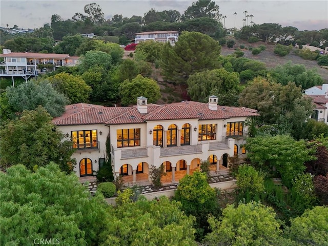 6337 Via Colinita, Rancho Palos Verdes, CA 90275 - rear view of property with a chimney, a tiled roof, stucco siding, a balcony, and view of wooded area