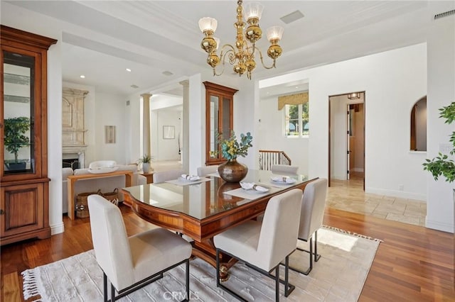 6337 Via Colinita, Rancho Palos Verdes, CA 90275 - dining space featuring a chandelier, light wood-style floors, decorative columns, recessed lighting, and a fireplace