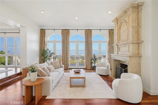6337 Via Colinita, Rancho Palos Verdes, CA 90275 - living area featuring healthy amount of natural light, a premium fireplace, wood finished floors, recessed lighting, and french doors
