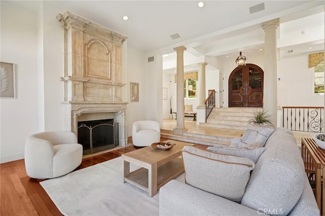 6337 Via Colinita, Rancho Palos Verdes, CA 90275 - living room featuring ornate columns, light wood-style floors, recessed lighting, a premium fireplace, and stairway
