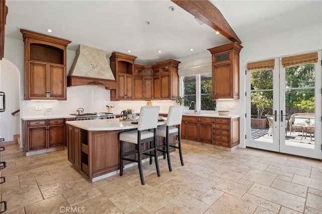 6337 Via Colinita, Rancho Palos Verdes, CA 90275 - kitchen with open shelves, custom range hood, stone tile floors, light countertops, and french doors