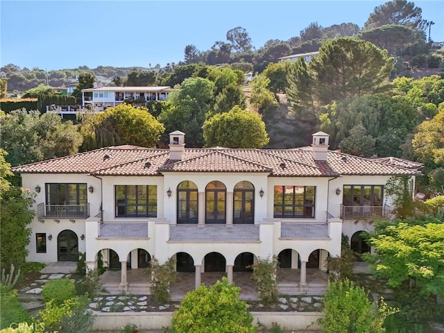6337 Via Colinita, Rancho Palos Verdes, CA 90275 - back of house with a chimney, a balcony, a tiled roof, stucco siding, and french doors