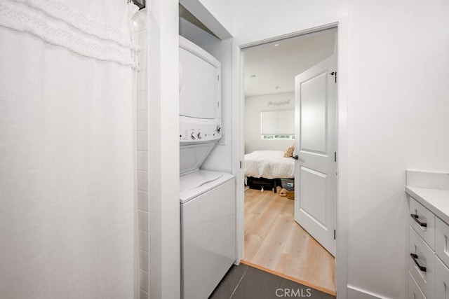 25252 Atwood Blvd, Newhall, CA 91321 - laundry area with stacked washer / drying machine and wood finished floors