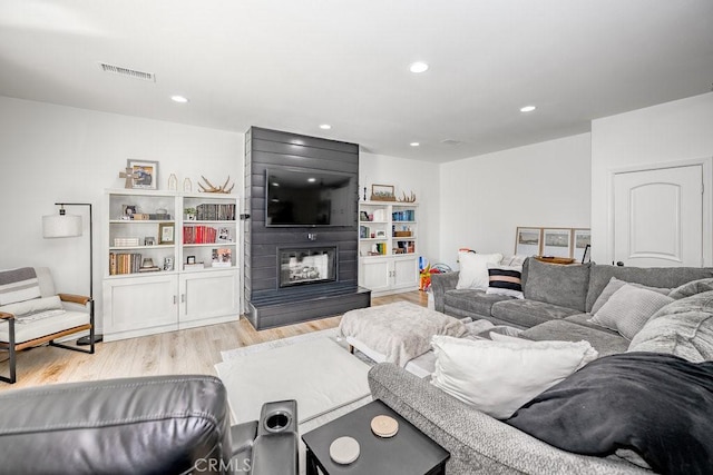 25252 Atwood Blvd, Newhall, CA 91321 - living room featuring light wood-style flooring, a large fireplace, and recessed lighting