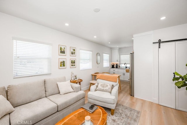 25252 Atwood Blvd, Newhall, CA 91321 - living area with light wood-type flooring, a barn door, and recessed lighting
