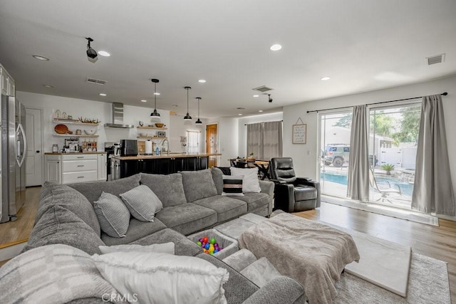 25252 Atwood Blvd, Newhall, CA 91321 - living room with light wood finished floors and recessed lighting