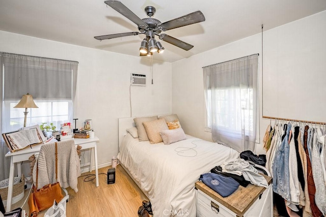 25252 Atwood Blvd, Newhall, CA 91321 - bedroom featuring wood finished floors, a wall unit AC, and a ceiling fan
