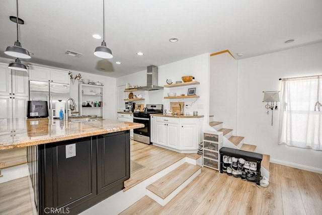 25252 Atwood Blvd, Newhall, CA 91321 - kitchen with stainless steel appliances, wall chimney range hood, white cabinetry, open shelves, and light wood finished floors