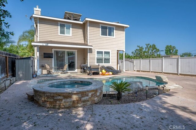 25252 Atwood Blvd, Newhall, CA 91321 - rear view of property featuring a fenced backyard, a chimney, an in-ground hot tub, and a patio area