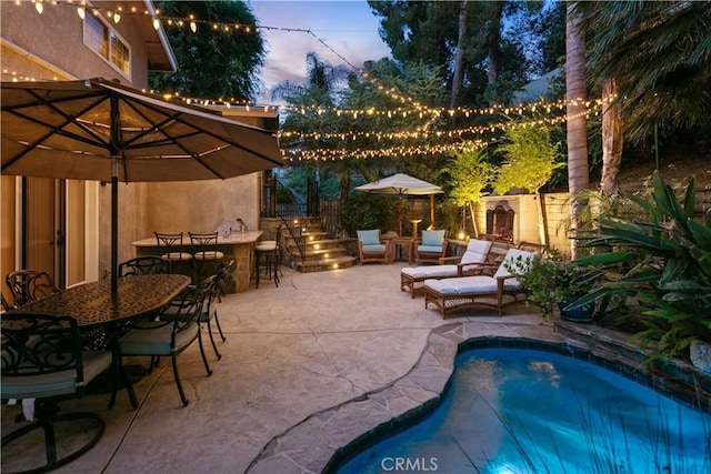 18836 Cedar Valley Way, Newhall, CA 91321 - pool at dusk with a patio area, an outdoor pool, and outdoor dining area