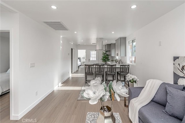 3818 Crawford St, Los Angeles, CA 90011 - living area featuring wood finished floors and recessed lighting