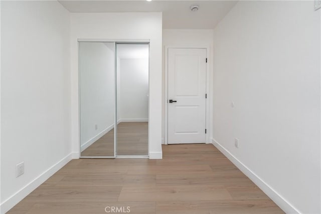 3818 Crawford St, Los Angeles, CA 90011 - unfurnished bedroom featuring light wood-style floors and a closet
