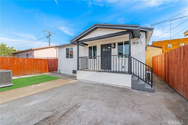 3818 Crawford St, Los Angeles, CA 90011 - view of front of property with stucco siding, a porch, and a patio area
