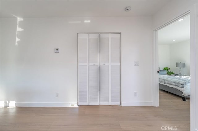 3818 Crawford St, Los Angeles, CA 90011 - unfurnished bedroom featuring light wood-style flooring and a closet