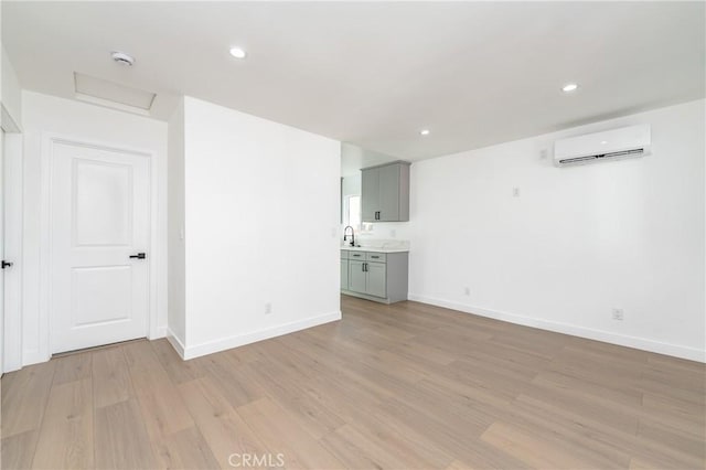 3818 Crawford St, Los Angeles, CA 90011 - unfurnished living room with a wall mounted air conditioner, light wood-style floors, attic access, and recessed lighting