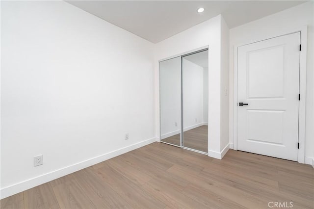 3818 Crawford St, Los Angeles, CA 90011 - unfurnished bedroom featuring light wood-style flooring, recessed lighting, and a closet