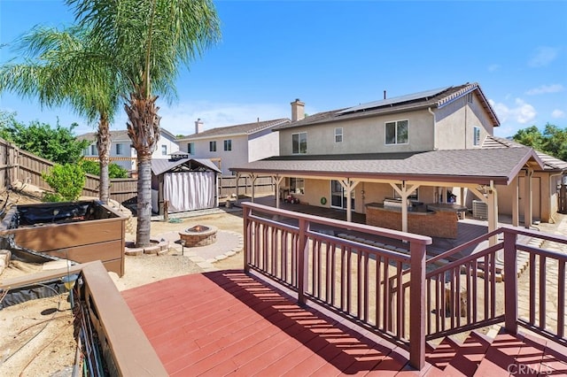 23050 Catt Rd, Wildomar, CA 92595 - wooden terrace featuring an outdoor fire pit, a shed, and a fenced backyard
