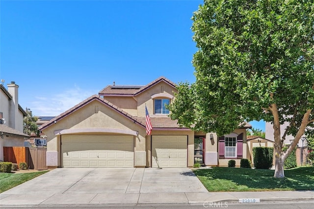 23050 Catt Rd, Wildomar, CA 92595 - view of front of property with roof mounted solar panels, concrete driveway, stucco siding, and a tiled roof