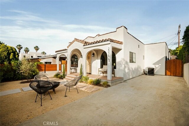 2334 Glover Pl, Los Angeles, CA 90031 - view of front of home with stucco siding, a gate, a fire pit, a tile roof, and a porch