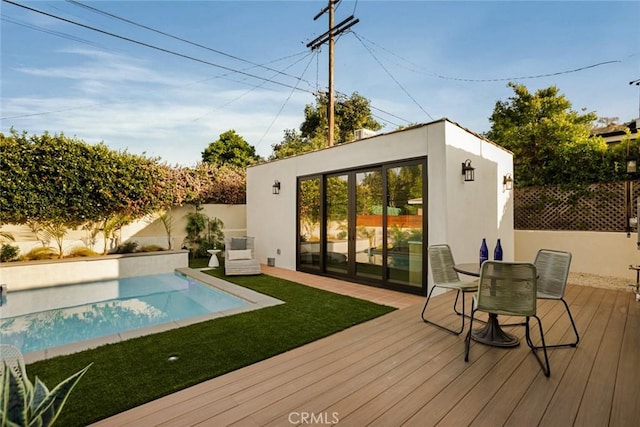 2334 Glover Pl, Los Angeles, CA 90031 - back of property with a fenced backyard, stucco siding, an outbuilding, and a wooden deck