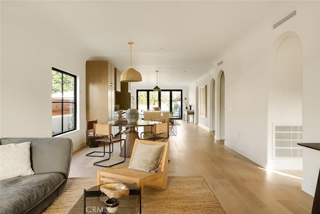 2334 Glover Pl, Los Angeles, CA 90031 - living area featuring light wood finished floors and arched walkways