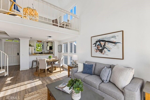 20371 Bluffside Cir Unit B401, Huntington Beach, CA 92646 - living area with wood finished floors, a high ceiling, and stairway