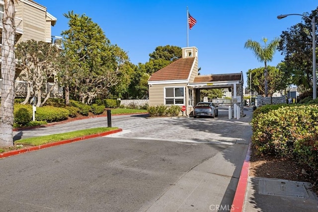 20371 Bluffside Cir Unit B401, Huntington Beach, CA 92646 - view of asphalt road featuring curbs and street lights