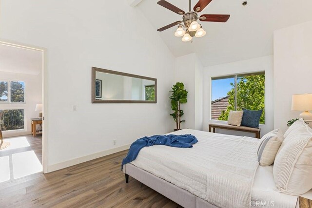 20371 Bluffside Cir Unit B401, Huntington Beach, CA 92646 - bedroom featuring high vaulted ceiling, wood finished floors, and ceiling fan