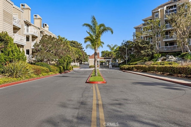 20371 Bluffside Cir Unit B401, Huntington Beach, CA 92646 - view of asphalt street with curbs, a gated entry, and sidewalks