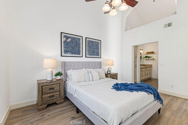 20371 Bluffside Cir Unit B401, Huntington Beach, CA 92646 - bedroom with wood finished floors, high vaulted ceiling, connected bathroom, and a ceiling fan