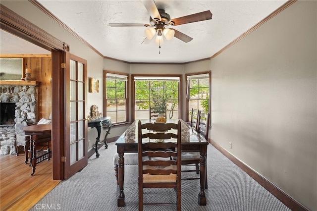10821 Los Jordans Rd, Agua Dulce, CA 91390 - dining space with crown molding, a ceiling fan, a fireplace, and wood finished floors