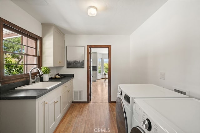 10821 Los Jordans Rd, Agua Dulce, CA 91390 - washroom with independent washer and dryer, cabinet space, and light wood-type flooring
