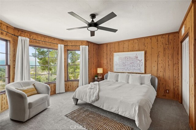 10821 Los Jordans Rd, Agua Dulce, CA 91390 - bedroom featuring light colored carpet, wood walls, and a ceiling fan