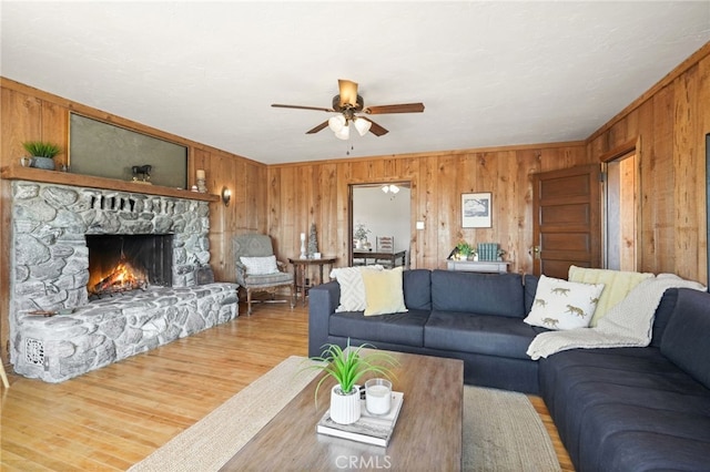 10821 Los Jordans Rd, Agua Dulce, CA 91390 - living room with wood walls, a ceiling fan, light wood-type flooring, a fireplace, and ornamental molding