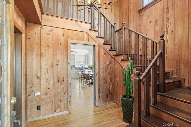 10821 Los Jordans Rd, Agua Dulce, CA 91390 - entryway with wood walls, wood finished floors, stairway, and a chandelier