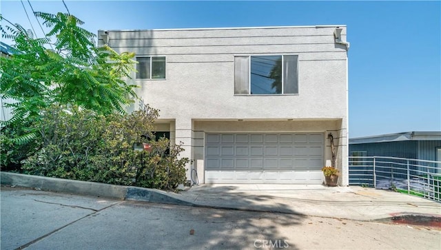 728 Quail Dr, Los Angeles, CA 90065 - view of property featuring a garage, driveway, and stucco siding
