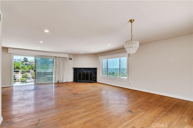 728 Quail Dr, Los Angeles, CA 90065 - unfurnished living room featuring light wood-style flooring, a high end fireplace, a chandelier, and recessed lighting
