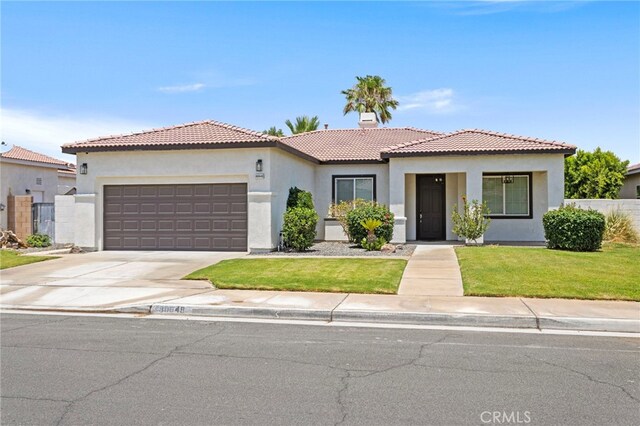 80848 Sunspring Ct, Indio, CA 92201 - view of front of house with stucco siding, a tile roof, an attached garage, and concrete driveway