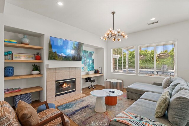 80848 Sunspring Ct, Indio, CA 92201 - living room featuring wood finished floors, a fireplace, a chandelier, and recessed lighting