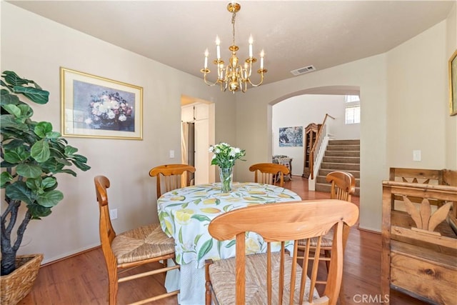 762 Twin Peaks Ave, Simi Valley, CA 93065 - dining room with stairway, arched walkways, wood finished floors, and a chandelier