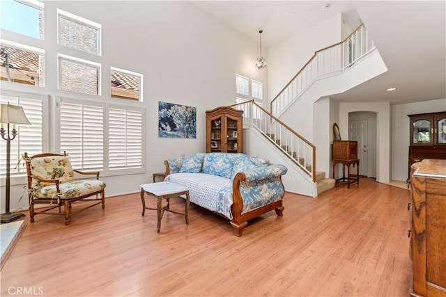 762 Twin Peaks Ave, Simi Valley, CA 93065 - living room with a towering ceiling, light wood-style flooring, stairway, and plenty of natural light