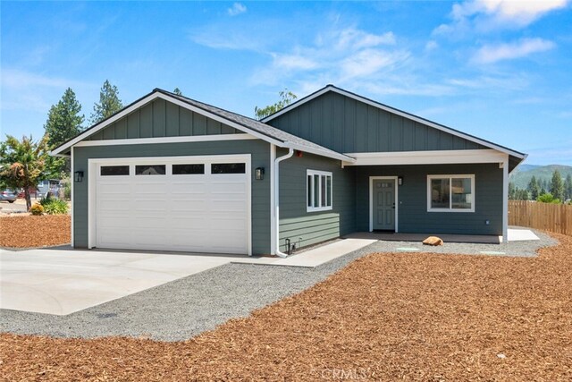 6105 Maxwood Dr, Paradise, CA 95969 - ranch-style home featuring concrete driveway, an attached garage, and covered porch