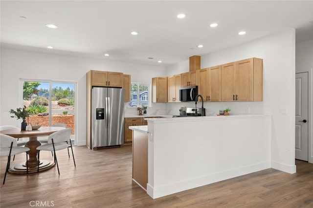 6105 Maxwood Dr, Paradise, CA 95969 - kitchen with stainless steel appliances, a peninsula, light countertops, recessed lighting, and light wood-type flooring