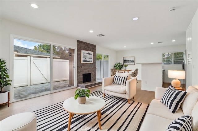 28512 Conejo View Dr, Agoura Hills, CA 91301 - living room with plenty of natural light, light wood-style floors, recessed lighting, and a stone fireplace
