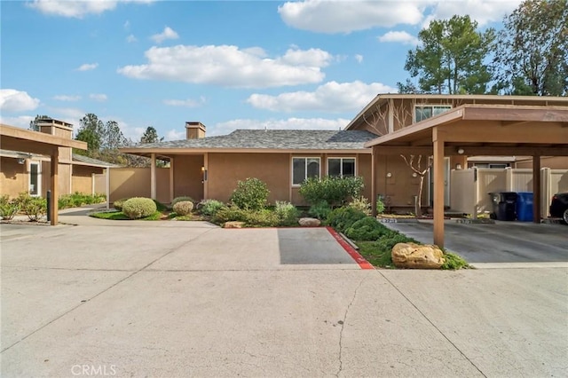 28512 Conejo View Dr, Agoura Hills, CA 91301 - view of front of house with stucco siding, a chimney, and covered parking