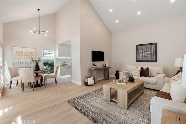 14 Willow Tree Ln, Irvine, CA 92612 - living area with high vaulted ceiling, a chandelier, light wood-type flooring, and recessed lighting